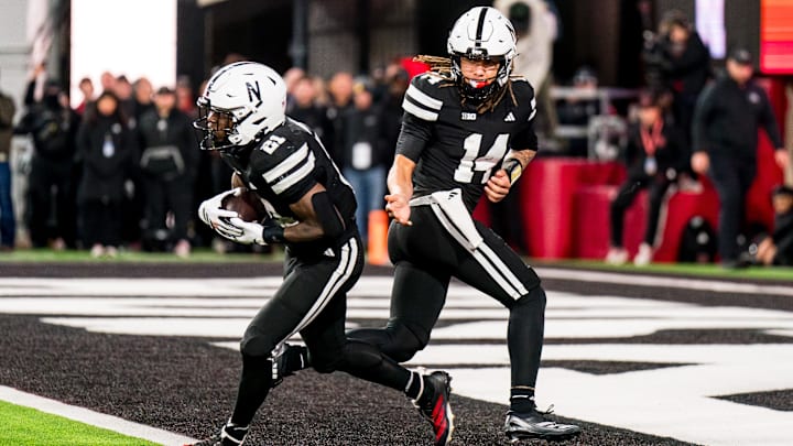 TJ Lateef hands the ball off to Emmett Johnson against USC. TJ Lateef hands the ball off to Emmett Johnson against USC.