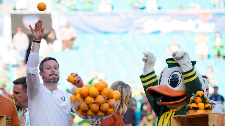 Oregon head coach Dan Lanning, left, throws out oranges as the team celebrates its win as the Oregon Ducks take on the Texas Tech Red Raiders in the Orange Bowl on Jan. 1, 2026, at Hard Rock Stadium in Miami, Florida.
