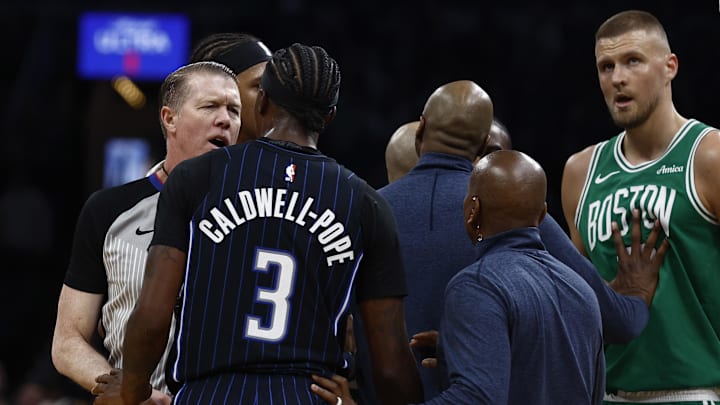 Referee Ed Malloy (14) talks to Orlando Magic guard Kentavious Caldwell-Pope (3) after he knocked down Boston Celtics center Al Horford (42) after colliding with him during the second quarter of game two of the first round of the 2024 NBA Playoffs at TD Garden.
