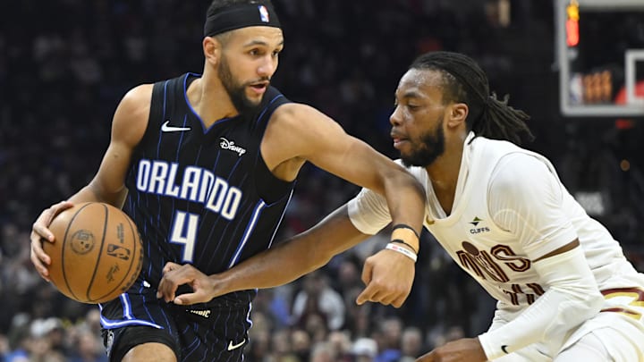 Feb 22, 2024; Cleveland, Ohio, USA; Orlando Magic guard Jalen Suggs (4) dribbles beside Cleveland Cavaliers guard Darius Garland (10) in the second quarter at Rocket Mortgage FieldHouse. Mandatory Credit: David Richard-Imagn Images