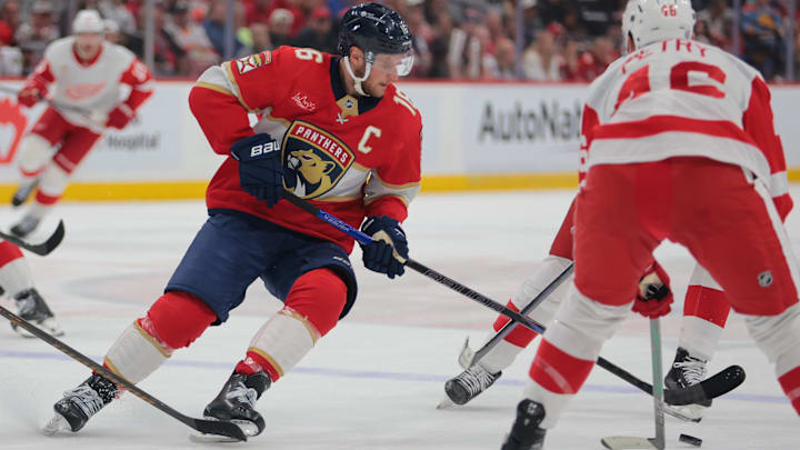 Apr 10, 2025; Sunrise, Florida, USA; Florida Panthers center Aleksander Barkov (16) moves the puck against Detroit Red Wings defenseman Jeff Petry (46) during the first period at Amerant Bank Arena. Mandatory Credit: Sam Navarro-Imagn Images