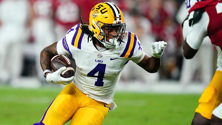Nov 4, 2023; Tuscaloosa, Alabama, USA; LSU Tigers running back John Emery Jr. (4) carries the ball against the Alabama Crimson Tide during the second quarter at Bryant-Denny Stadium. Mandatory Credit: John David Mercer-Imagn Images