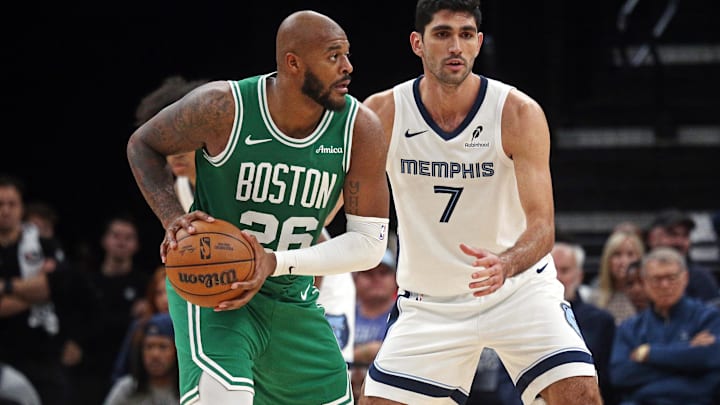 Oct 8, 2025; Memphis, Tennessee, USA; Boston Celtics forward Xavier Tillman Sr. (26) handles the ball as Memphis Grizzlies forward Santi Aldama (7) defends during the fourth quarter at FedExForum. Mandatory Credit: Petre Thomas-Imagn Images