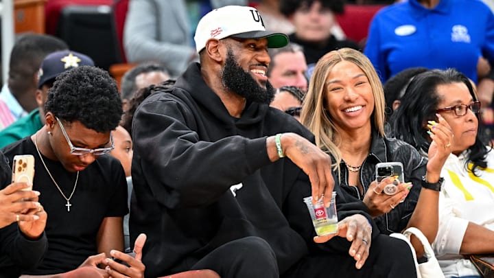 Los Angeles Laker LeBron James and his wife Savannah James sit court side at the McDonald's All American game during the first half at Toyota Center. 