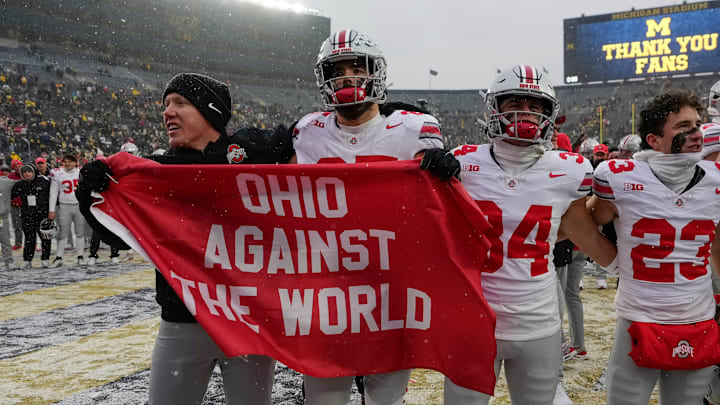 Ohio State Buckeyes tight ends coach Keenan Bailey celebrates with tight end Bennett Christian (85), wide receiver Brennen Schramm (34) and wide receiver Nolan Baudo (23) following the NCAA football game against the Michigan Wolverines at Michigan Stadium in Ann Arbor, Mich. on Nov. 29, 2025. Ohio State won 27-9.