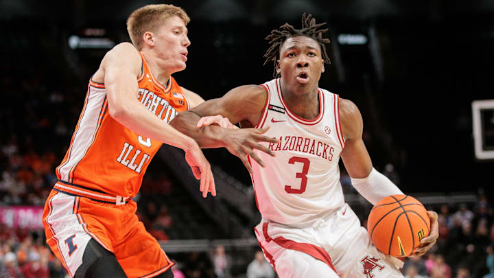 Nov 28, 2024; Kansas City, Missouri, USA; Arkansas Razorbacks forward Adou Thiero (3) drives around Illinois Fighting Illini forward Ben Humrichous (3) during the first half at T-Mobile Center. Mandatory Credit: William Purnell-Imagn Images