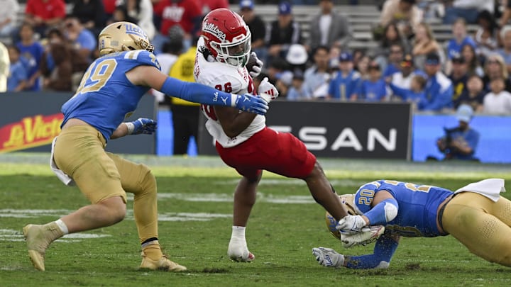 Nov 30, 2024; Pasadena, California, USA; UCLA Bruins linebacker Carson Schwesinger (49) and linebacker Kain Medrano (20) stop Fresno State Bulldogs running back Bryson Donelson (26) in the fourth quarter at Rose Bowl. Mandatory Credit: Robert Hanashiro-Imagn Images Nov 30, 2024; Pasadena, California, USA; UCLA Bruins linebacker Carson Schwesinger (49) and linebacker Kain Medrano (20) stop Fresno State Bulldogs running back Bryson Donelson (26) in the fourth quarter at Rose Bowl. Mandatory Credit: Robert Hanashiro-Imagn Images