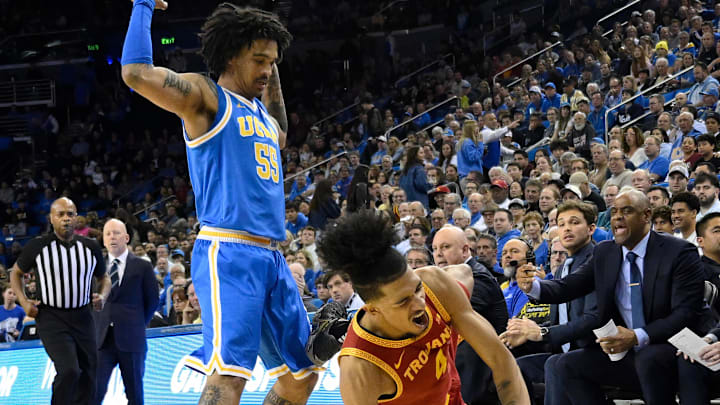 Feb 24, 2026; Los Angeles, California, USA; Southern California Trojans guard Chad Baker-Mazara (4) hits the floor as he tries to drive past UCLA Bruins guard Skyy Clark (55) during the first half at Pauley Pavilion presented by Wescom Financial. Mandatory Credit: Robert Hanashiro-Imagn Images Feb 24, 2026; Los Angeles, California, USA; Southern California Trojans guard Chad Baker-Mazara (4) hits the floor as he tries to drive past UCLA Bruins guard Skyy Clark (55) during the first half at Pauley Pavilion presented by Wescom Financial. Mandatory Credit: Robert Hanashiro-Imagn Images