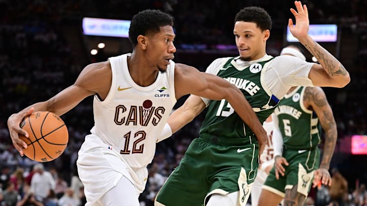 Oct 26, 2025; Cleveland, Ohio, USA; Cleveland Cavaliers guard De'Andre Hunter (12) drives to the basket against Milwaukee Bucks guard Ryan Rollins (13) during the second half at Rocket Arena. Mandatory Credit: Ken Blaze-Imagn Images