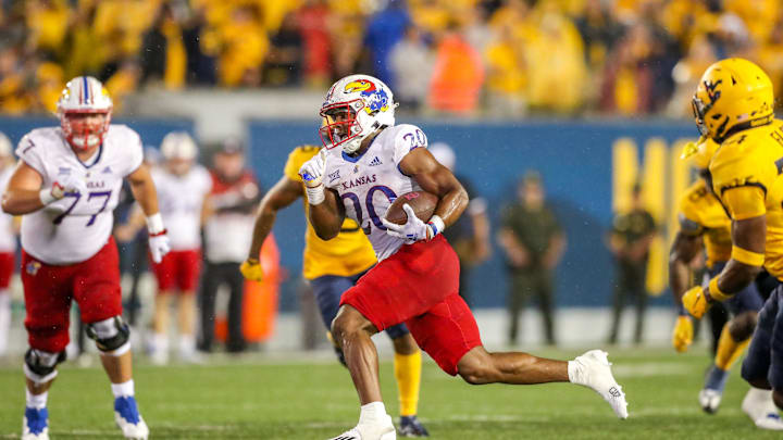 Sep 10, 2022; Morgantown, West Virginia, USA; Kansas Jayhawks running back Daniel Hishaw Jr. (20) runs the ball for a touchdown during the fourth quarter against the West Virginia Mountaineers at Mountaineer Field at Milan Puskar Stadium. Mandatory Credit: Ben Queen-Imagn Images