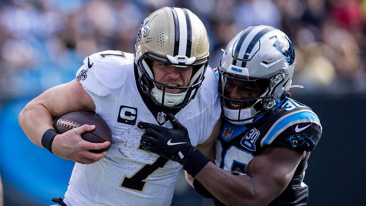 Nov 3, 2024; Charlotte, North Carolina, USA; New Orleans Saints tight end Taysom Hill (7) is hit by Carolina Panthers safety Demani Richardson (36) during the first quarter at Bank of America Stadium. Mandatory Credit: Scott Kinser-Imagn Images Nov 3, 2024; Charlotte, North Carolina, USA; New Orleans Saints tight end Taysom Hill (7) is hit by Carolina Panthers safety Demani Richardson (36) during the first quarter at Bank of America Stadium. Mandatory Credit: Scott Kinser-Imagn Images