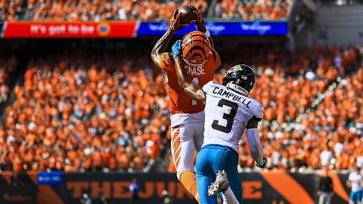 Sep 14, 2025; Cincinnati, Ohio, USA; Cincinnati Bengals wide receiver Ja'Marr Chase (1) catches a pass against Jacksonville Jaguars cornerback Tyson Campbell (3) in the second half at Paycor Stadium. Mandatory Credit: Katie Stratman-Imagn Images