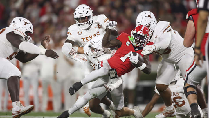 Georgia Bulldogs wide receiver Zachariah Branch (1) is tackle by Texas Longhorns defensive back Michael Taaffe (16) and defensive tackle Hero Kanu (93) in the first half at Sanford Stadium.