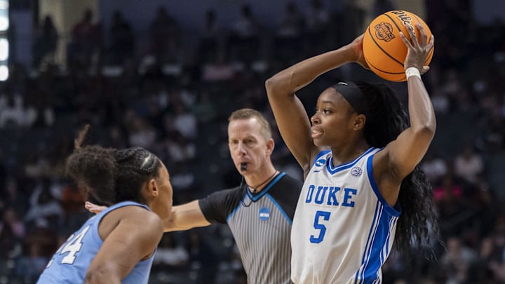 Mar 28, 2025; Birmingham, AL, USA; Duke Blue Devils guard Oluchi Okananwa (5) looks to pass over North Carolina Tar Heels guard Indya Nivar (24) during the Sweet 16 NCAA Tournament basketball game at Legacy Arena. Mandatory Credit: Vasha Hunt-Imagn Images
