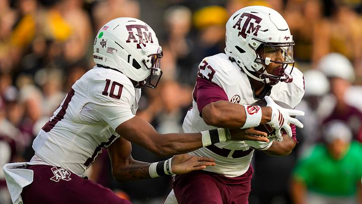 Nov 8, 2025; Columbia, Missouri, USA; Texas A&M Aggies running back Jamarion Morrow (23) takes the handoff from quarterback Marcel Reed (10) during the first half against the Missouri Tigers at Faurot Field at Memorial Stadium. Mandatory Credit: Jay Biggerstaff-Imagn Images