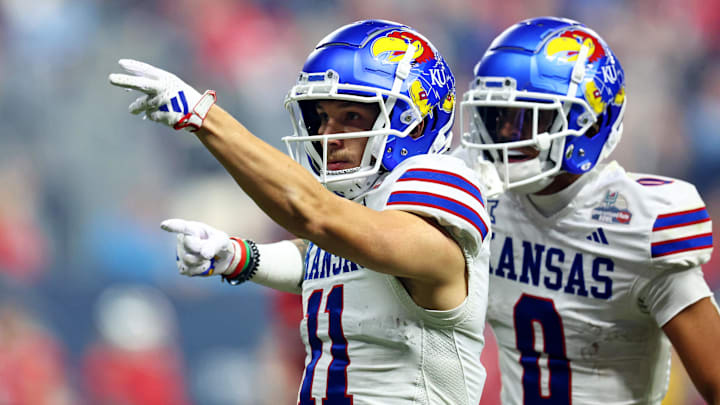 Dec 26, 2023; Phoenix, AZ, USA; Kansas Jayhawks wide receiver Luke Grimm (11) celebrates with wide receiver Quentin Skinner (0)