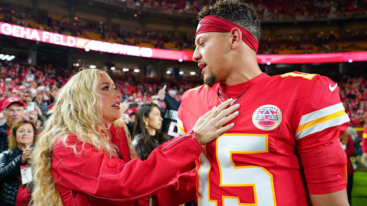Oct 27, 2025; Kansas City, Missouri, USA; Kansas City Chiefs quarterback Patrick Mahomes (15) greets wife, Brittany Mahomes, during warmups prior to the game against the Washington Commanders at GEHA Field at Arrowhead Stadium.
