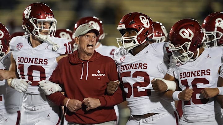 Nov 9, 2024; Columbia, Missouri, USA; Oklahoma Sooners head coach Brent Venables locks arms with his team prior to a game against the Missouri Tigers at Faurot Field at Memorial Stadium. Mandatory Credit: Jay Biggerstaff-Imagn Images