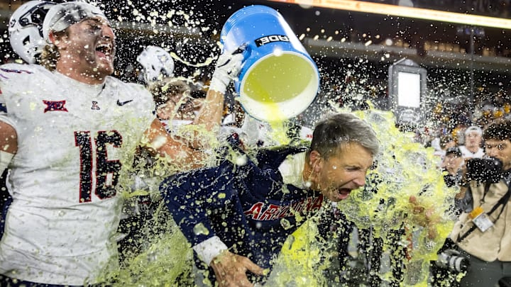 Nov 28, 2025; Tempe, Arizona, USA; Arizona Wildcats head coach Brent Brennan is doused with Powerade after defeating the Arizona State Sun Devils during the 99th Territorial Cup at Mountain America Stadium. Mandatory Credit: Mark J. Rebilas-Imagn Images