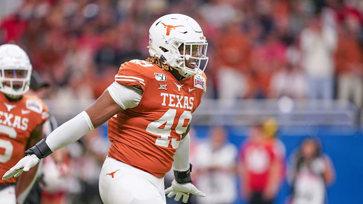 Dec 31, 2019; San Antonio, Texas, USA;  Texas Longhorns defensive lineman Ta'Quon Graham (49) celebrates a sack in the first half against the Utah Utes at the Alamodome. Mandatory Credit: Daniel Dunn-Imagn Images