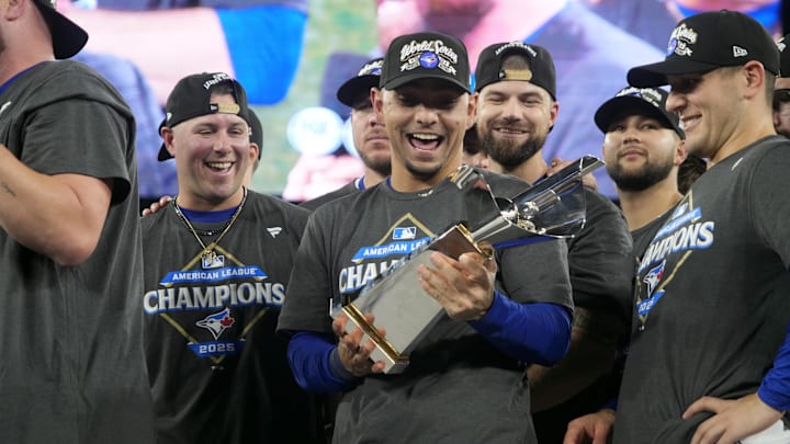 Oct 20, 2025; Toronto, Ontario, CAN; Toronto Blue Jays second baseman Andres Gimenez (0) celebrates with the trophy after defeating the in game seven of the ALCS round for the 2025 MLB playoffs at Rogers Centre. Mandatory Credit: John E. Sokolowski-Imagn Images Oct 20, 2025; Toronto, Ontario, CAN; Toronto Blue Jays second baseman Andres Gimenez (0) celebrates with the trophy after defeating the in game seven of the ALCS round for the 2025 MLB playoffs at Rogers Centre. Mandatory Credit: John E. Sokolowski-Imagn Images