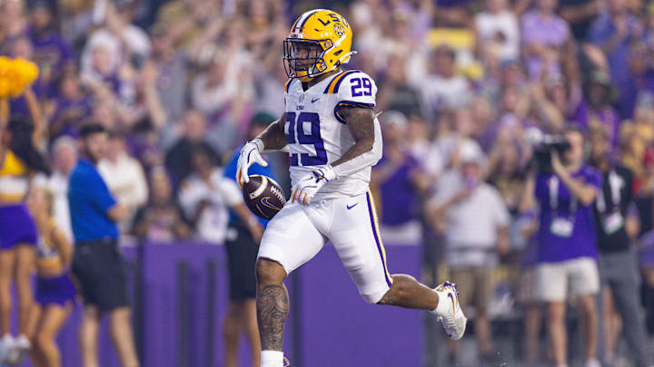 Sep 28, 2024; Baton Rouge, Louisiana, USA; LSU Tigers running back Caden Durham (29) runs in a 71-yard touchdown pass from quarterback Garrett Nussmeier (not pictured) against South Alabama Jaguars safety Jaden Voisin (2) during the first quarter at Tiger Stadium. Mandatory Credit: Stephen Lew-Imagn Images Sep 28, 2024; Baton Rouge, Louisiana, USA; LSU Tigers running back Caden Durham (29) runs in a 71-yard touchdown pass from quarterback Garrett Nussmeier (not pictured) against South Alabama Jaguars safety Jaden Voisin (2) during the first quarter at Tiger Stadium. Mandatory Credit: Stephen Lew-Imagn Images