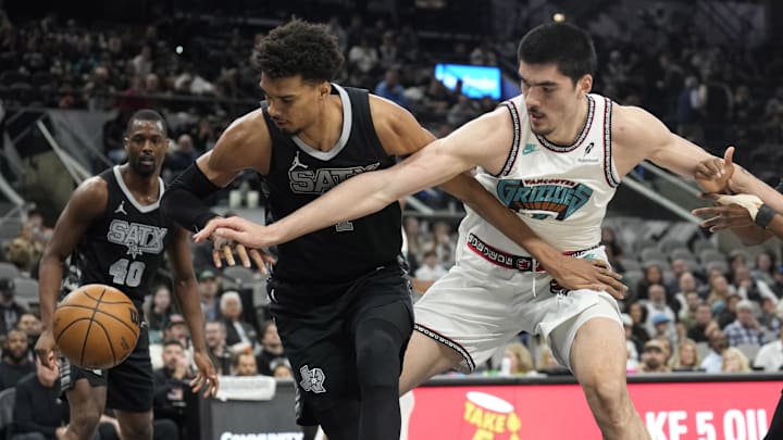 Jan 15, 2025; San Antonio, Texas, USA; San Antonio Spurs center Victor Wembanyama (1) and Memphis Grizzlies center Zach Edey (14) battle for a loose ball during the first half at Frost Bank Center. Mandatory Credit: Scott Wachter-Imagn Images