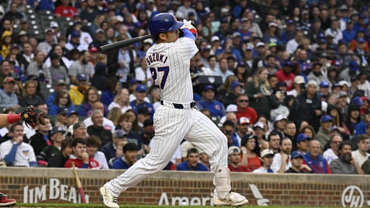 Sep 28, 2024; Chicago, Illinois, USA;  Chicago Cubs outfielder Seiya Suzuki (27) hits a single against the Cincinnati Reds during the first inning at Wrigley Field.