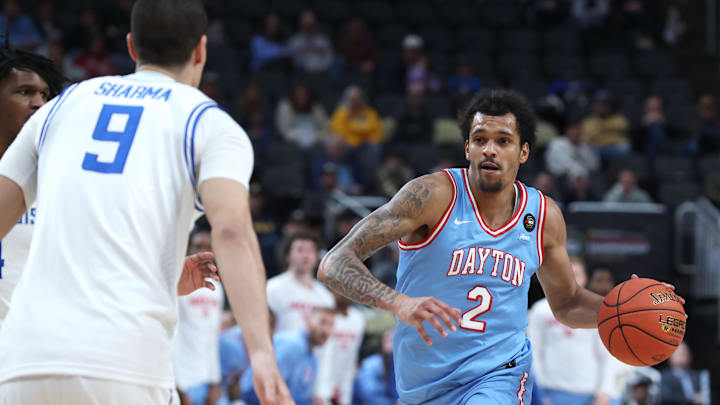 Mar 14, 2026; Pittsburgh, PA, USA;  Dayton Flyers guard De'shayne Montgomery (2) brings the ball up court against Saint Louis Billikens forward Ishan Sharma (9) during the first half in an Atlantic 10 Conference Tournament Semifinal game at PPG Paints Arena. Mandatory Credit: Charles LeClaire-Imagn Images