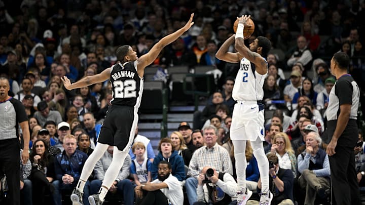 Feb 23, 2023; Dallas, Texas, USA; Dallas Mavericks guard Kyrie Irving (2) makes a three point shot over San Antonio Spurs guard Malaki Branham (22) during the second half at the American Airlines Center. Mandatory Credit: Jerome Miron-Imagn Images