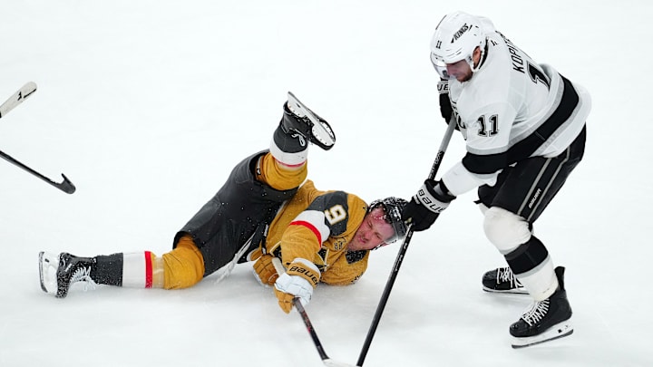 Mar 9, 2025; Las Vegas, Nevada, USA; Los Angeles Kings center Anze Kopitar (11) takes the puck from a fallen Vegas Golden Knights center Jack Eichel (9) during the third period at T-Mobile Arena. Mandatory Credit: Stephen R. Sylvanie-Imagn Images