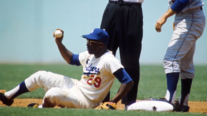1966; Los Angeles, CA, USA: FILE PHOTO; Los Angeles Dodgers short stop Nate Oliver (29) holds the ball up after New York Mets second baseman Ron Hunt (33) makes it to second base at Dodger Stadium. Mandatory Credit: Darryl Norenberg-Imagn Images 1966; Los Angeles, CA, USA: FILE PHOTO; Los Angeles Dodgers short stop Nate Oliver (29) holds the ball up after New York Mets second baseman Ron Hunt (33) makes it to second base at Dodger Stadium. Mandatory Credit: Darryl Norenberg-Imagn Images