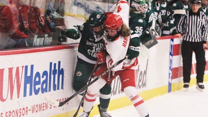 Wisconsin's Caroline Harvey (4) and Bemidji State's Shelby Sandberg fight for the puck during the first period of the Badgers' 3-2 overtime victory Saturday Feb. 28, 2026 at LaBahn Arena in Madison, Wisconsin. Wisconsin's Caroline Harvey (4) and Bemidji State's Shelby Sandberg fight for the puck during the first period of the Badgers' 3-2 overtime victory Saturday Feb. 28, 2026 at LaBahn Arena in Madison, Wisconsin.