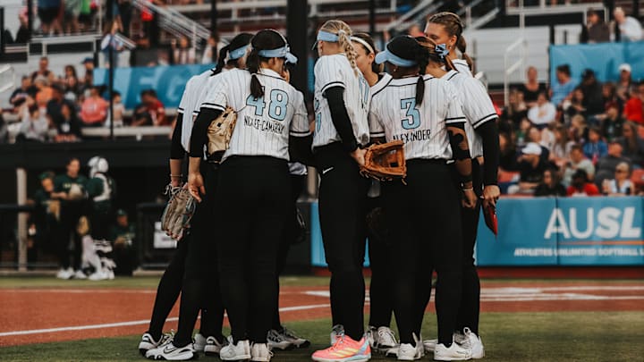 AUSL Bandits players circle up before the start of an inning.