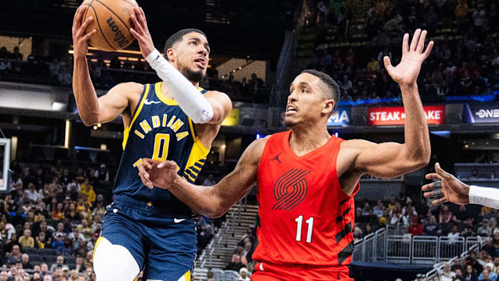 Nov 27, 2023; Indianapolis, Indiana, USA; Indiana Pacers guard Tyrese Haliburton (0) shoots the ball while Portland Trail Blazers guard Malcolm Brogdon (11)  defends in the second half at Gainbridge Fieldhouse. Mandatory Credit: Trevor Ruszkowski-Imagn Images