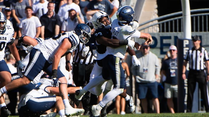 Penn State's Dani Dennis-Sutton hits Nevada quarterback Chubba Purdy in the first half of an NCAA football game at Beaver Stadium. 