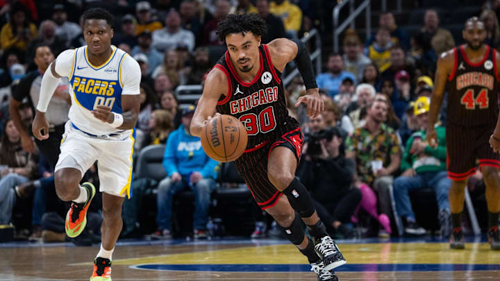 Nov 29, 2025; Indianapolis, Indiana, USA; Chicago Bulls guard Tre Jones (30) brings the ball up court against Indiana Pacers guard Bennedict Mathurin (00) during the first half at Gainbridge Fieldhouse. Mandatory Credit: Trevor Ruszkowski-Imagn Images