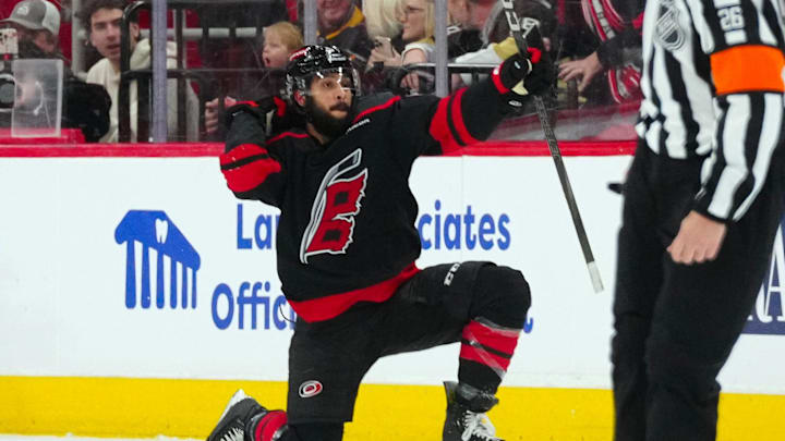 Jan 5, 2025; Raleigh, North Carolina, USA;  Carolina Hurricanes defenseman Jalen Chatfield (5) celebrates his goal against the Pittsburgh Penguins during the second period at Lenovo Center. Mandatory Credit: James Guillory-Imagn Images