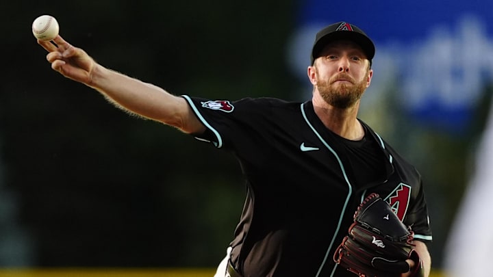Jun 21, 2025; Denver, Colorado, USA; Arizona Diamondbacks starting pitcher Merrill Kelly (29) delivers a pitch in the first inning against the Colorado Rockies at Coors Field.