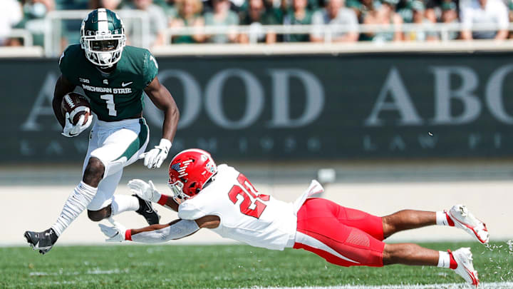 Michigan State wide receiver Jayden Reed (1) returns a punt against Youngstown State cornerback Johntavious Davis-Bonner (20) during the first half at Spartan Stadium in East Lansing on Saturday, Sept. 11, 2021. Michigan State wide receiver Jayden Reed (1) returns a punt against Youngstown State cornerback Johntavious Davis-Bonner (20) during the first half at Spartan Stadium in East Lansing on Saturday, Sept. 11, 2021.