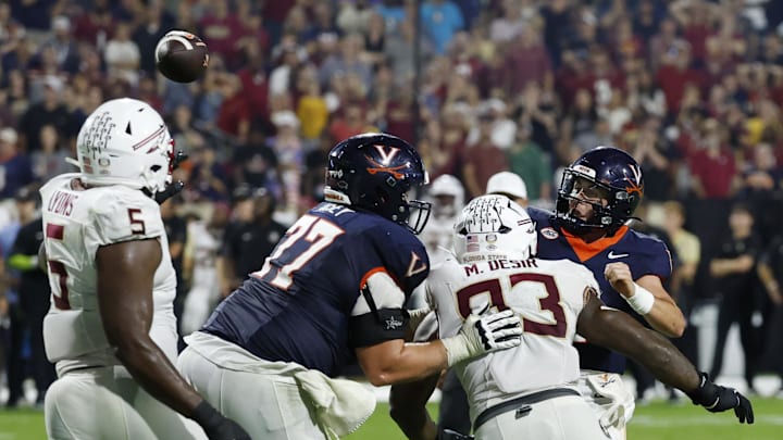 Sep 26, 2025; Charlottesville, Virginia, USA; Virginia Cavaliers quarterback Chandler Morris (4) completes a two point conversion as Florida State Seminoles defensive lineman Mandrell Desir (93) chases during the second overtime period at Scott Stadium. Mandatory Credit: Geoff Burke-Imagn Images