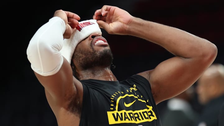 Dec 14, 2025; Portland, Oregon, USA; Golden State Warriors guard Buddy Hield (7) reacts while shooting the ball with his hat covering his eyes during warm ups before playing against the Portland Trail Blazers at Moda Center. Mandatory Credit: Jaime Valdez-Imagn Images