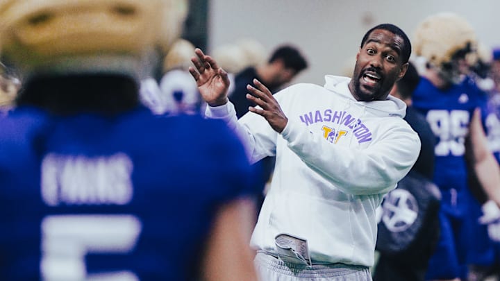 Kevin Cummings demonstrates a receiving technique during spring ball. 
