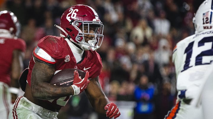 Nov 30, 2024; Tuscaloosa, Alabama, USA; Alabama Crimson Tide running back Jam Miller (26) runs the ball against the Auburn Tigers during the third quarter at Bryant-Denny Stadium. Mandatory Credit: Will McLelland-Imagn Images Nov 30, 2024; Tuscaloosa, Alabama, USA; Alabama Crimson Tide running back Jam Miller (26) runs the ball against the Auburn Tigers during the third quarter at Bryant-Denny Stadium. Mandatory Credit: Will McLelland-Imagn Images