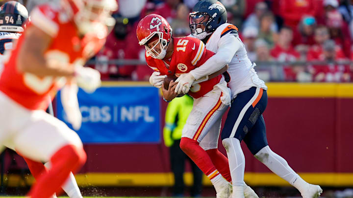 Kansas City Chiefs quarterback Patrick Mahomes (15) is sacked but Denver Broncos linebacker Jonathon Cooper (0) during the second half at GEHA Field at Arrowhead Stadium.