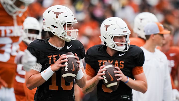 Texas Longhorns quarterbacks Arch Manning, left, and Quinn Ewers, right, throw passes while warming up ahead of the Longhorns' spring Orange and White game at Darrell K Royal Texas Memorial Stadium. 