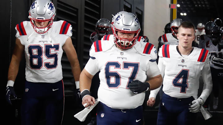 Dec 7, 2023; Pittsburgh, Pennsylvania, USA;  New England Patriots tight end Hunter Henry (85) and center Jake Andrews (67) and quarterback Bailey Zappe (4) take the field against the Pittsburgh Steelers at Acrisure Stadium. Mandatory Credit: Charles LeClaire-Imagn Images