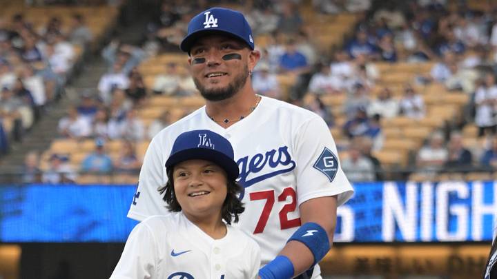 Los Angeles Dodgers shortstop Miguel Rojas (72) with his son Aaron and daughter Amber watch the video board of their dad’s world series home run prior to the game against the Atlanta Braves at Dodger Stadium on May 8, 2026.