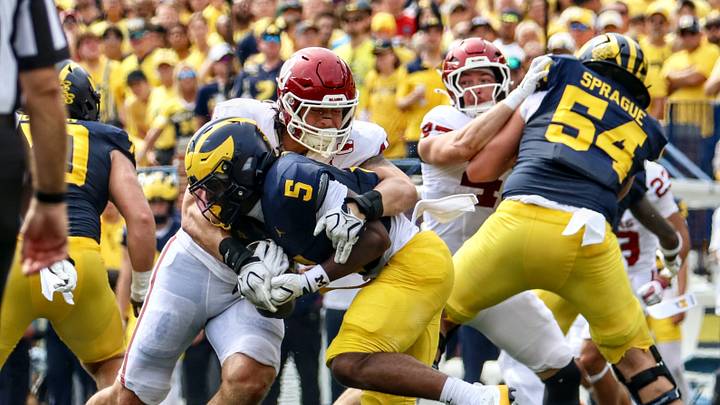 Oklahoma defensive end Taylor Wein tackles Michigan running back Savion Hiter. Oklahoma defensive end Taylor Wein tackles Michigan running back Savion Hiter.