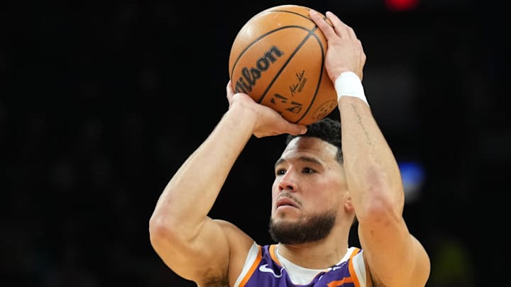 Nov 6, 2024; Phoenix, Arizona, USA; Phoenix Suns guard Devin Booker (1) shoots against the Miami Heat during the first half at Footprint Center. Mandatory Credit: Joe Camporeale-Imagn Images